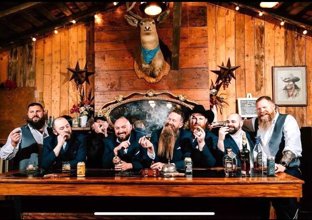 Wedding party inside the western saloon at Chisholm Trail Rustic Venue
